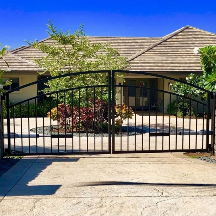Image of a gate in front of a large home