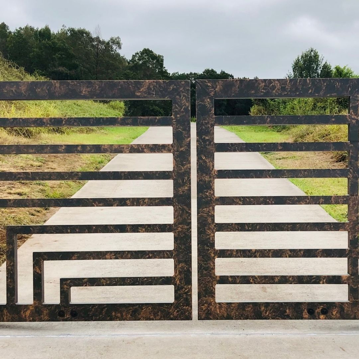 electric gate closed with a pathway behind it