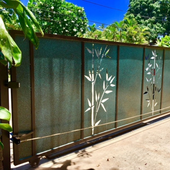 Solid frosted gate featuring decorative metal bamboo cutouts.