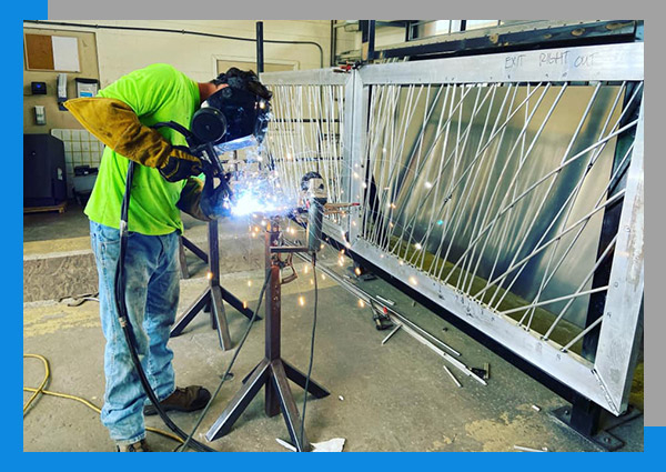 Image of a welder providing gate repair service.