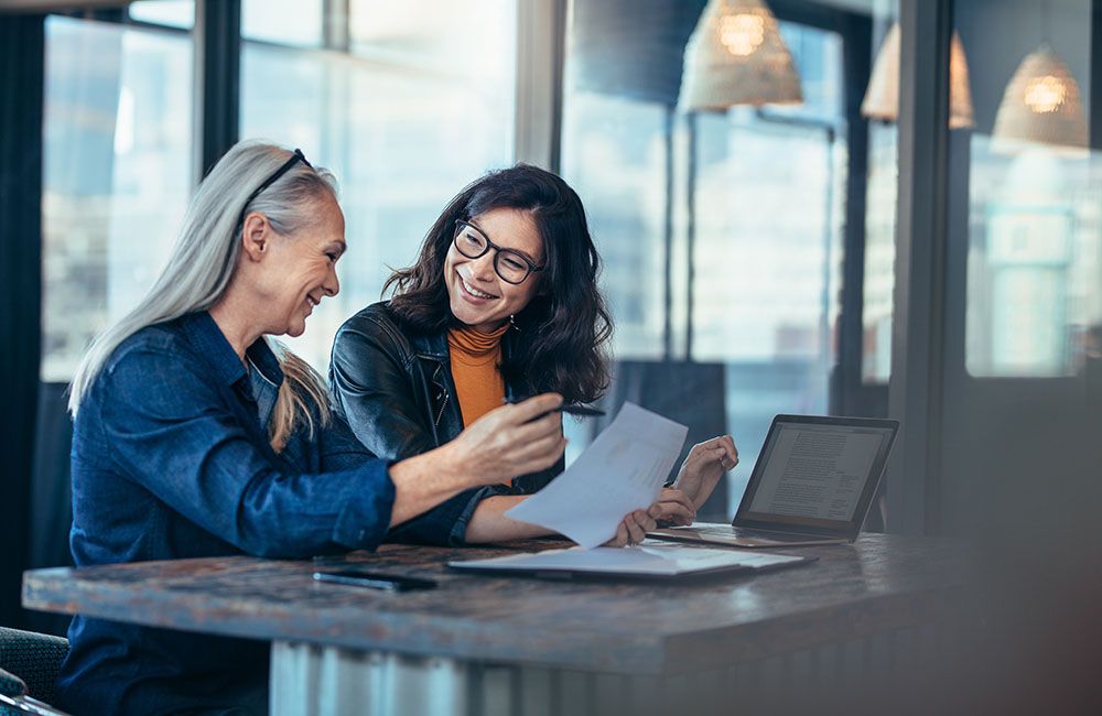 Older woman working with younger employee