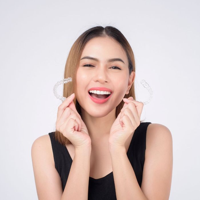 woman holding invisalign