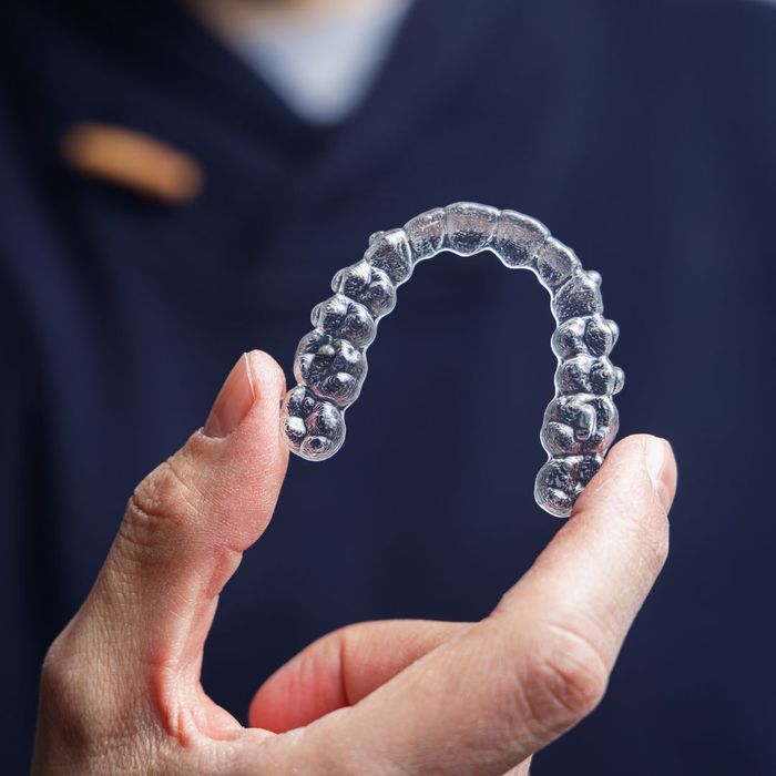 dentist holding invisalign