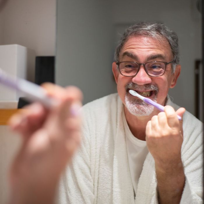 man brushing his teeth