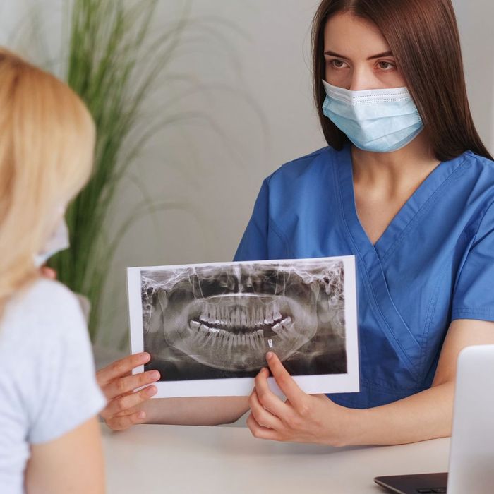 dentist showing patient x-rays