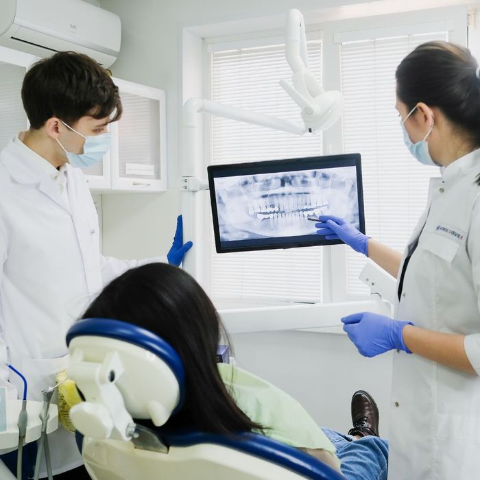 dentist showing x-rays to patient