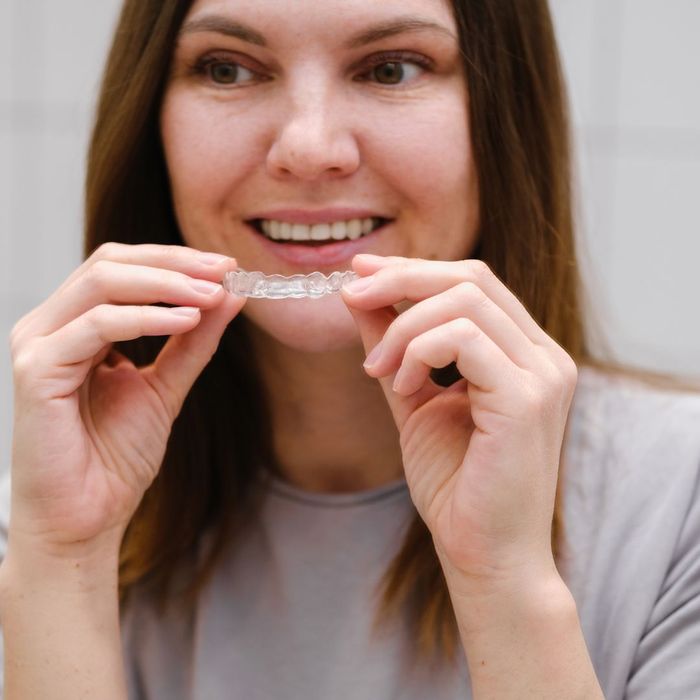 woman holding invisalign