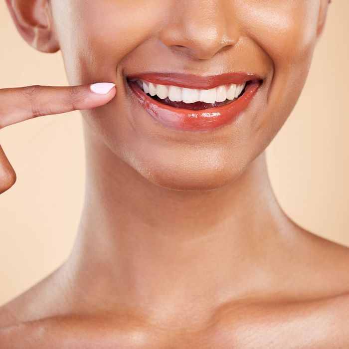 woman pointing at her smile