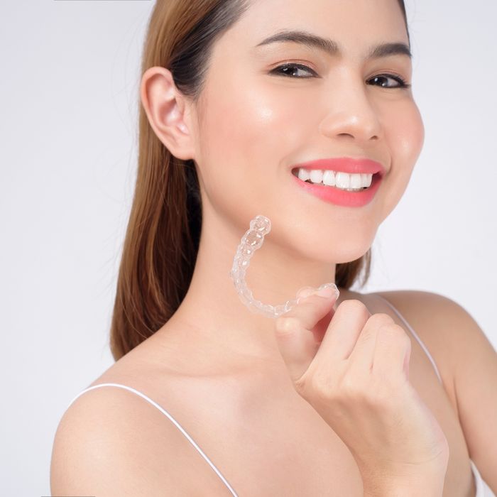 Woman modeling with invisalign