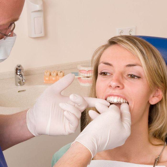 Invisalign being placed into someones mouth