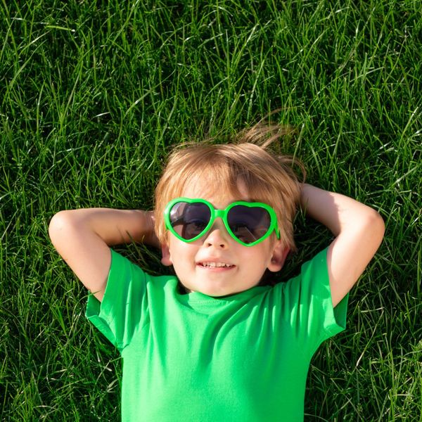kid laying on grass
