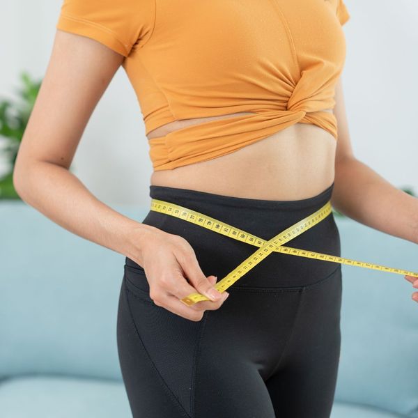 Women measuring her waist 