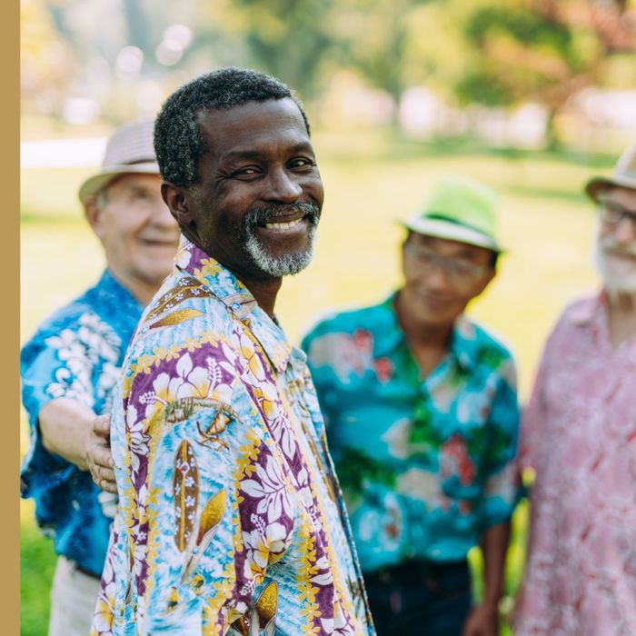 elderly men in Hawaiian shirts chatting outdoors