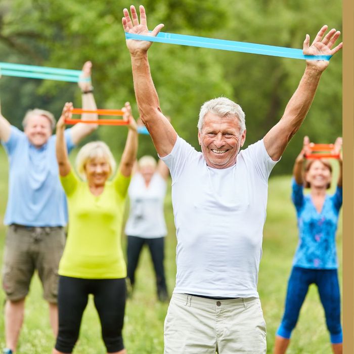 group of smiling seniors exercising outdoors