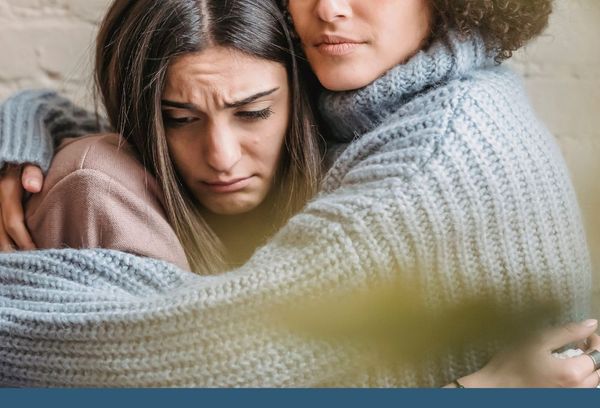 2 girls hugging and consoling