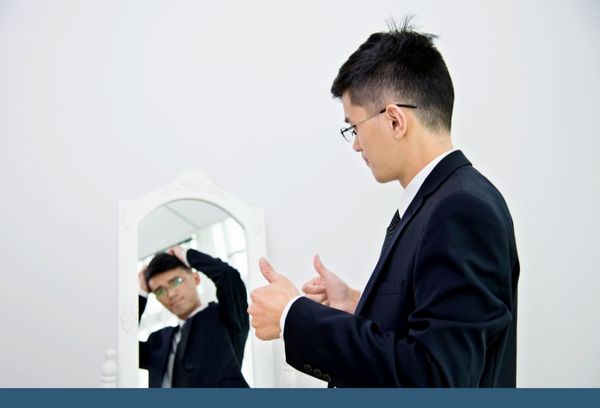 male looking at himself in mirror