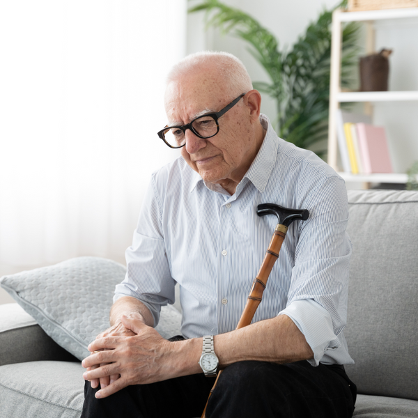 Old man holding knee in pain