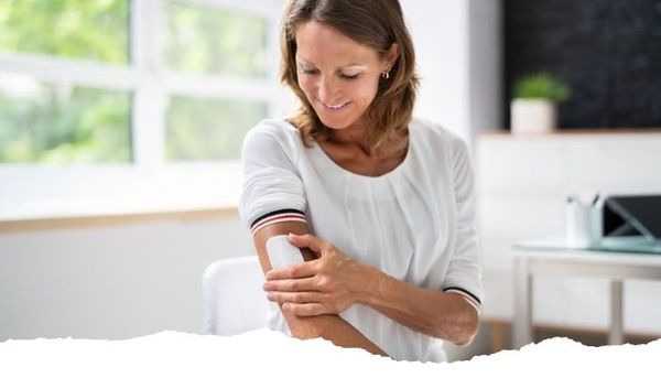 older woman applying estrogen patch older woman applying estrogen patch
