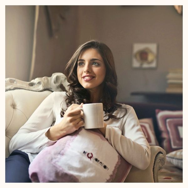 woman on couch with mug