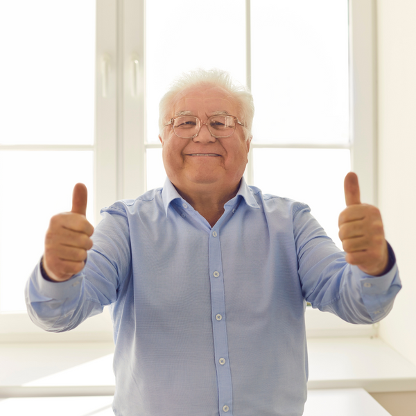 Happy old man holding two thumbs up