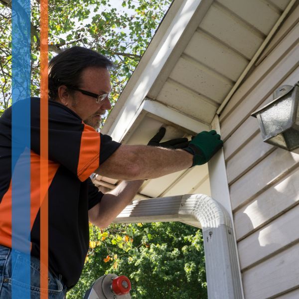 a man fixing siding