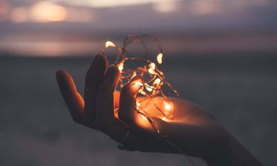 Hand holding lights during sunset