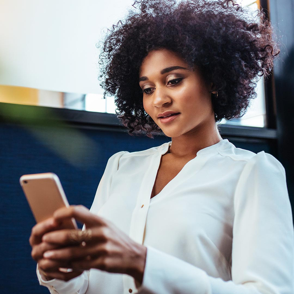 Happy woman using her phone