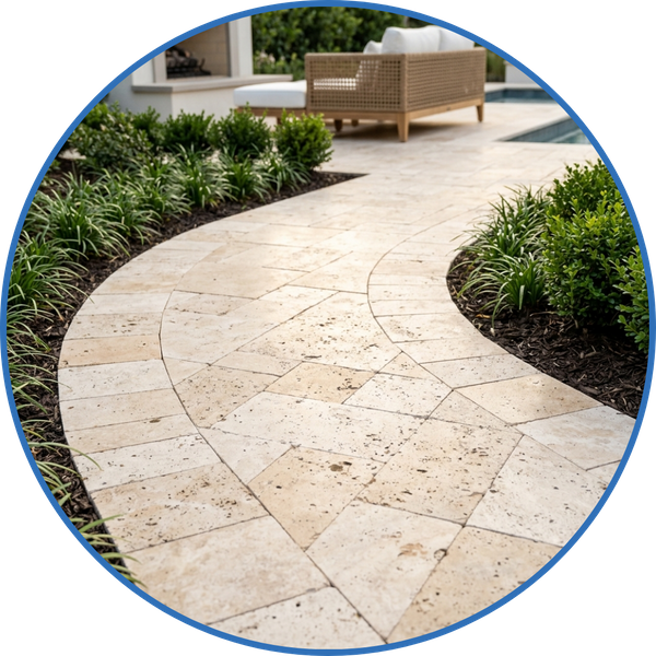 Elegant travertine paver pathway winding through a beautifully landscaped outdoor space. 