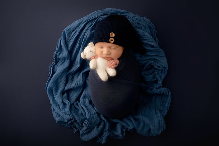 Baby in Blue with a teddy bear