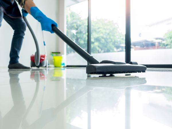 A janitor cleans a building’s floors.