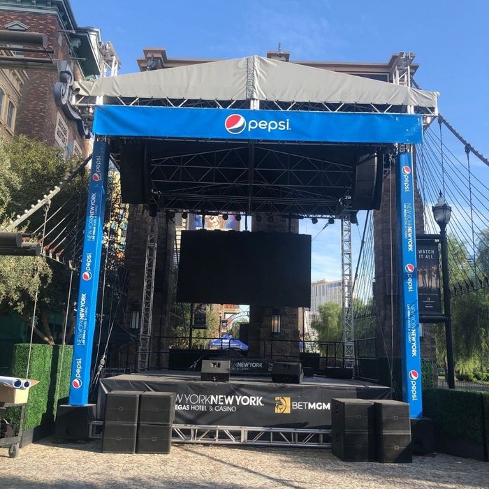 Pepsi signs hanging on the top and sides of an outdoor stage