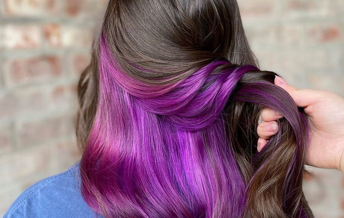 dark hair with a bright purple peek-a-boo coloring