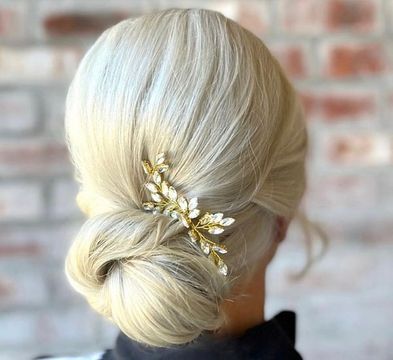 blond updo with bejeweled hair piece