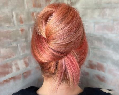 peachy pink hair in an updo