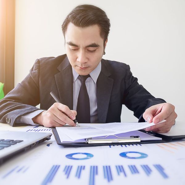 man looking at bookkeeping materials