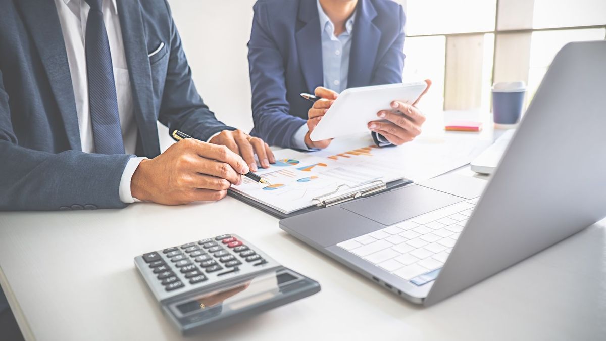 Accountants looking at balance sheets together