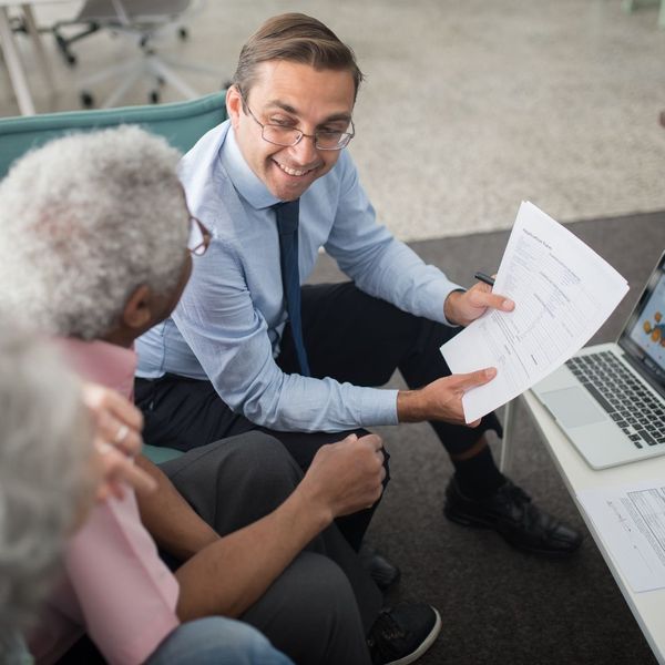 accountant going over documents with older man accountant going over documents with older man
