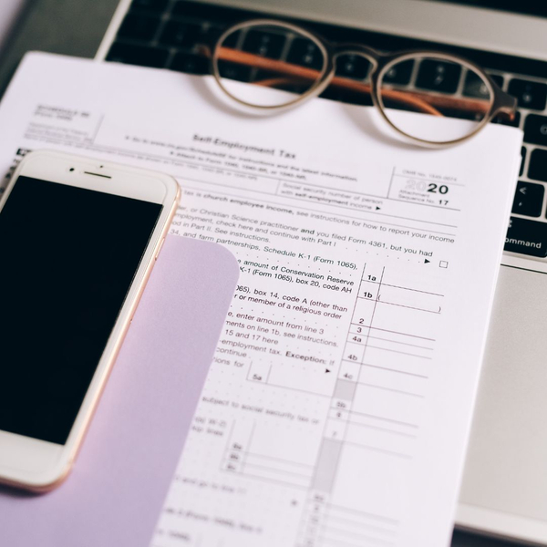 Tax document, phone, and glasses Tax document, phone, and glasses