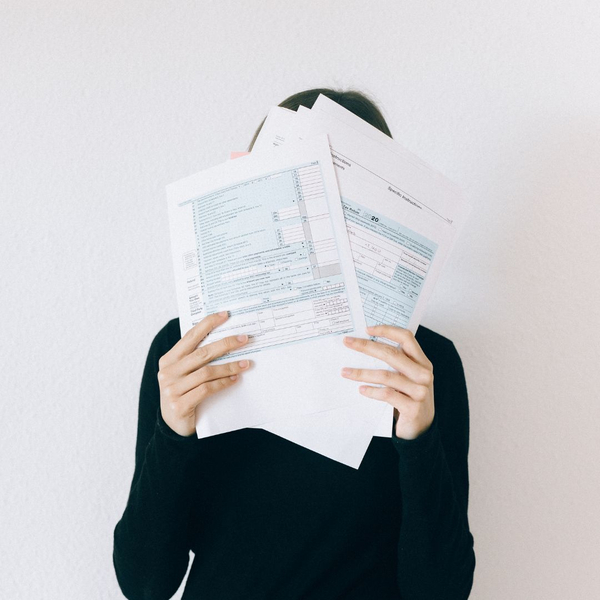 woman holding tax documents woman holding tax documents