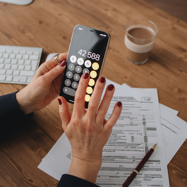 Person using their phone calculator Person using their phone calculator