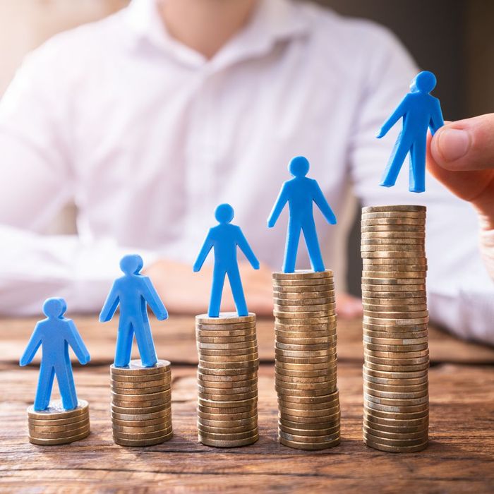 people standing on different piles of money