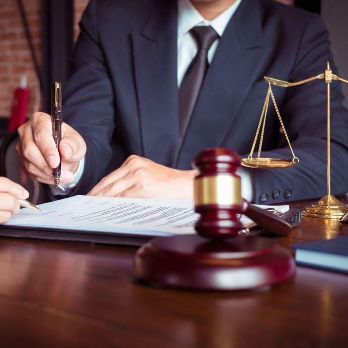 lawyer at desk with gavel and scales