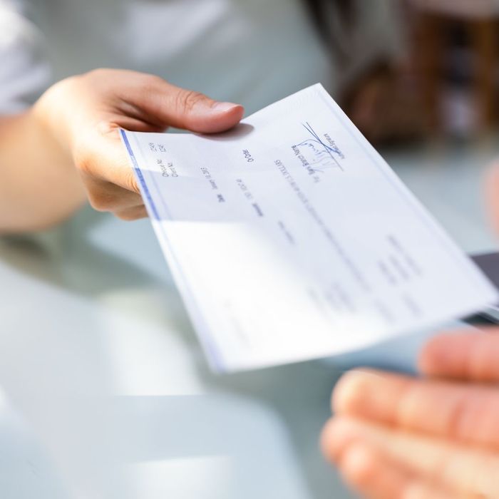 pay check being handed to employee