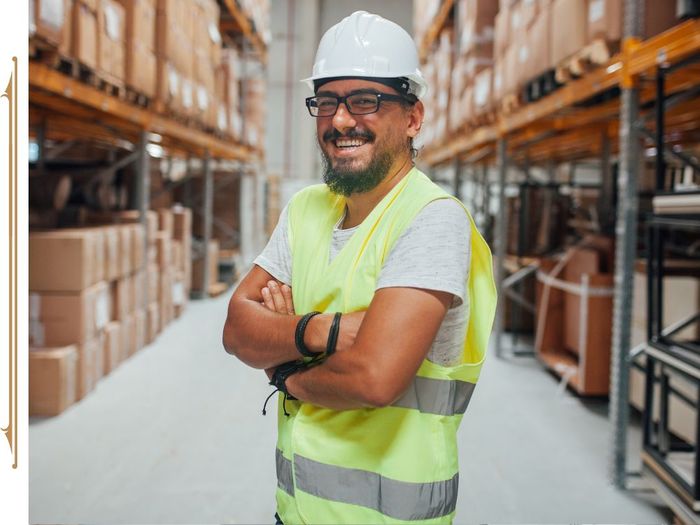 Warehouse worker wearing a hardhat and yellow vest