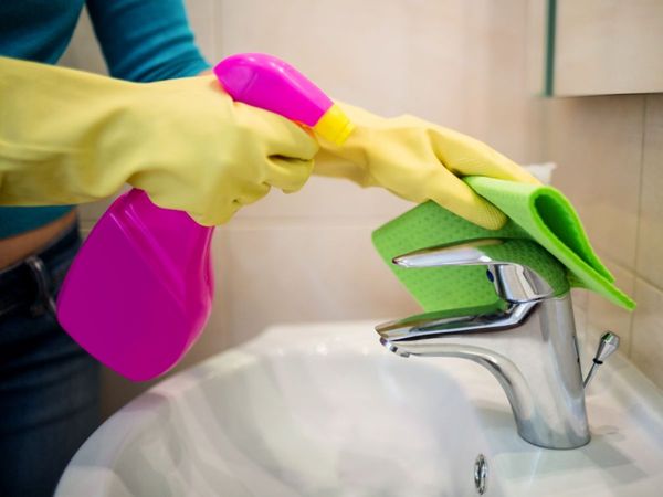 Woman cleaning sink