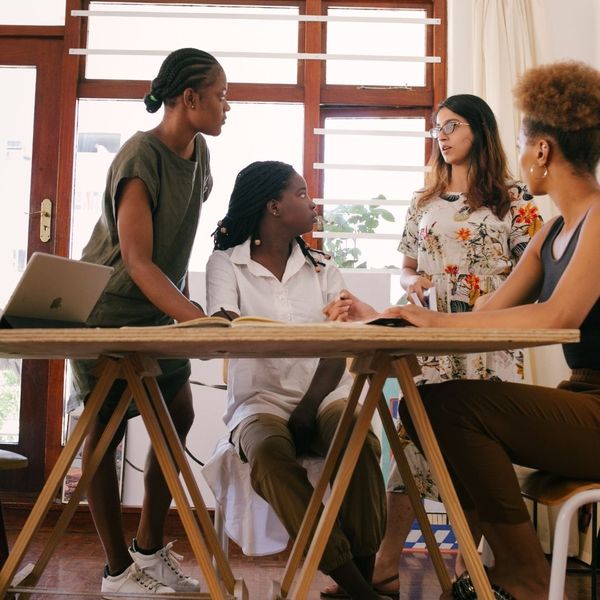 four people discuss plans at a table