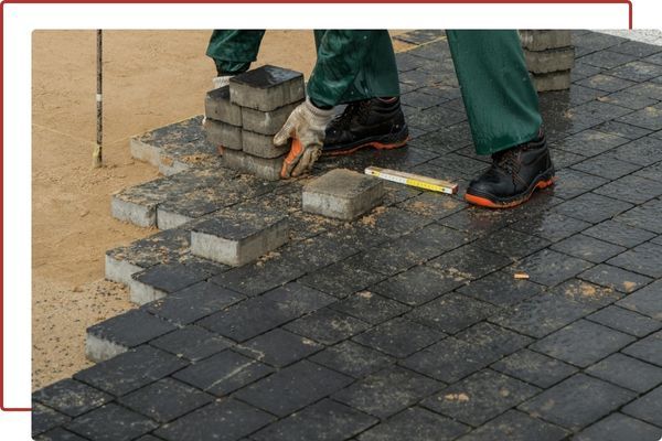 worker installing pavers