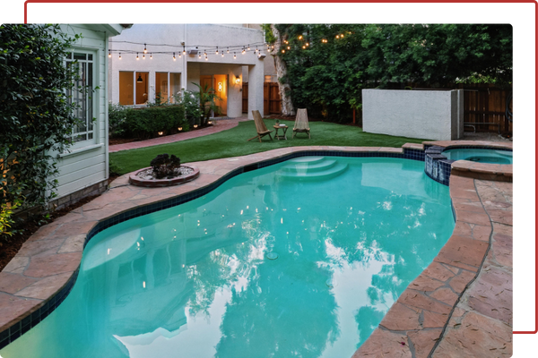 residential home with a pool and turf