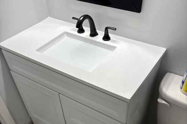 Modern black facuet with a white sink