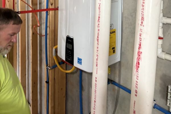 Employee looking at a water heater